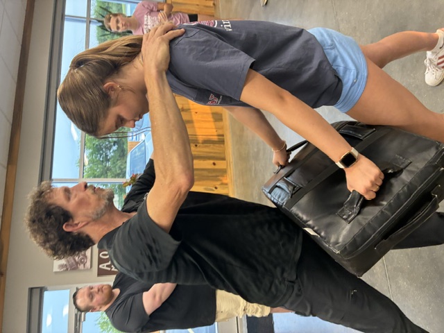 Brandon Tracy demonstrating a technique one-on-one with a participant