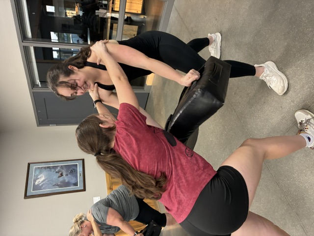 Two participants working a technique together, laughing as they go