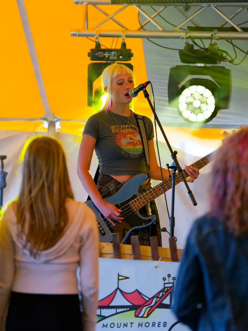 Leah Kellesvig singing and playing bass with the band at the Frolic