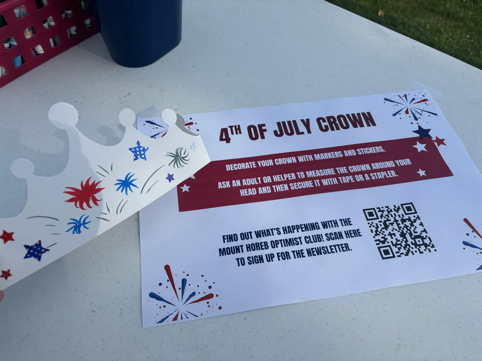 A decorated paper Fourth of July crown beside its instruction card